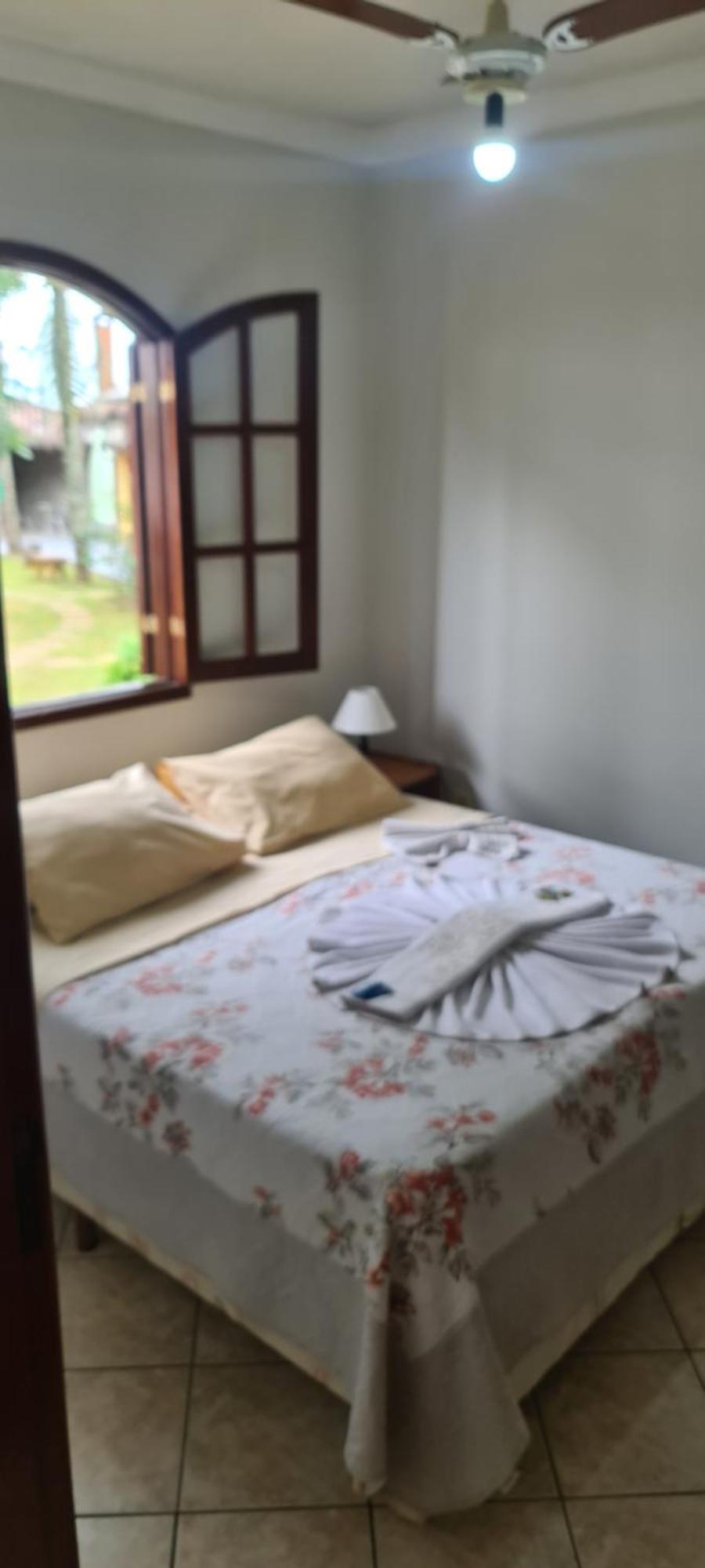 Pousada Nossa Senhora Penedo  Phòng bức ảnh A bed with a bathrobe